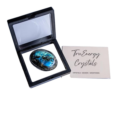Labradorite stone in an open display case with 'TruEnergy Crystals' card on a white background