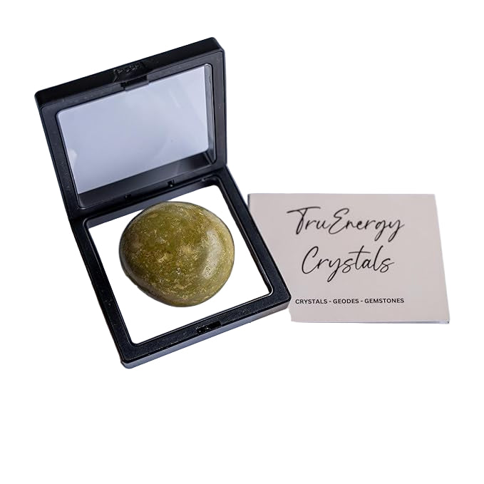Green crystal stone in a black display case with 'TruEnergy Crystals' card on a white background